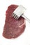 Raw filet mignon and meat tenderizer
