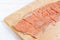 Raw fillet pink salmon with salt and pepper on wooden board