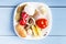 Raw fish, egg and natural ingredients for dietary dish cooking on wooden background. Top view on uncooked products. Copy space