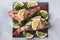 Raw fish perch without a head with lemon slices and dill greens on a slate stand concrete background. Top view Copy space. Healthy