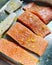 Raw fish prepared for baking, fresh salmon, pieces of cod on a baking tray, fish prepared for baking, macerated pieces of salmon