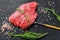 Raw Flat iron steak with rosemary and pink salt. Fresh Marble beef meat black Angus. Black background. Top view