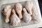 Raw Floured and Spiced Chicken Drumsticks on a Wire Rack