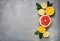 raw food: slicing citrus fruits. Orange, tangerine, lemon lime grapefruit
