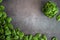 Raw fresh baby spinach leaves in bowl on grey background. Frame made of spinach background. Top view healthy leaf