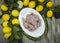 Raw fresh chicken on porcelain plate with lemon and chilli on the wooden background