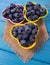 Raw fresh huckleberry in a bowl. Wooden background