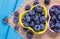 Raw fresh huckleberry in a bowl. Wooden background