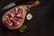 Raw fresh Lamb Meat ribs and seasonings on wooden cutting board.