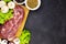 Raw fresh marble meat steak and seasonings on a dark marble background, top view