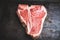 Raw fresh marble T-bone meat on the rustic background