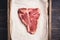 Raw fresh marble T-bone meat on the rustic background