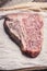 Raw fresh marble T-bone meat on the rustic background