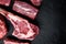 Raw fresh marbled meat Steak, seasonings, tomahawk, t bone, club steak, rib eye and tenderloin cuts, on black stone background,