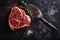 Raw fresh meat, Ribeye steak, seasoning and meat fork on grey board. AI generated.