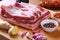 Raw fresh meat, uncooked lamb or beef ribs with pepper, garlic, salt and spices on dark stone background, Ready for
