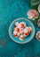 Raw fresh seafood shellfish scallops on blue background