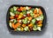 Raw fresh seasonal vegetables on a baking sheet. Sweet potato, zucchini, sweet pepper, cherry tomatoes, garlic, broccoli cabbage,