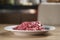 Raw fresh sliced beef for beefsteaks in plate on kitchen table