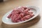 Raw fresh sliced beef for beefsteaks in plate on kitchen table