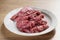 Raw fresh sliced beef for beefsteaks in plate on kitchen table