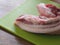 Raw Fresh Streaky Pork On Green Cutting Board