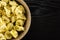 Raw Fresh tortellini pasta on black wood