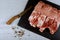 Raw fresh uncooked Pork Meat cutting chopping board for cutting raw of pork