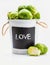 Raw, fresh, whole and cut brussels sprouts cabbages - Brassica oleracea in bowl with the word `love`.