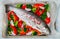 Raw fresh whole fish salmon, trout with vegetables