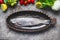 Raw fresh whole trout in baking dish with vegetables cooking ingredients on gray concrete background , top view