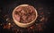 Raw game, beef meat in cubes, in a bowl, on a black background, blackboard. Diced red meat marinated with seasonings.