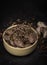 Raw game, beef meat in cubes, in a bowl, on a black background, blackboard. Diced red meat with seasonings, close up.