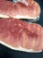 Raw Gammon steaks cooking on a hot plate