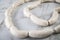 Raw German Bavarian WeiÃŸwurst white sausage chain on marble background