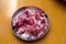 Raw goat red meat pieces in a steel plate