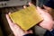 Raw gold ingot in the hands