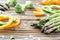 Raw green asparagus, pepper slices and broccoli . Wooden table