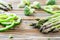 Raw green asparagus, pepper slices and broccoli . Wooden table