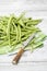 Raw green beans (Phaseolus vulgaris) antique knife on cloth napkin