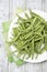 Raw green beans (Phaseolus vulgaris) on plate