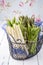 Raw green and white asparagus in a black basket on a rustic wooden shabby chic table