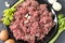 Raw ground beef in a plate, celery, garlic cloves, eggs onion, meat