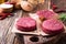 Raw ground beef, round patties for making burgers