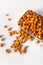 Raw Groundnuts in an earthen bowl on white background.