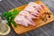 Raw gutted quails and condiments prepared for cooking on wooden table