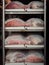 Raw ham during the salting process inside a refrigeration cell.