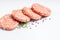 Raw Hamburger,meatballs on white background. fast food at home.Convenience food, precooked.Raw chicken burger on a white plate in