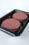 Raw Hamburger Patties in a Plastic Tray