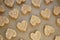 Raw heart-shaped cookies on baking paper